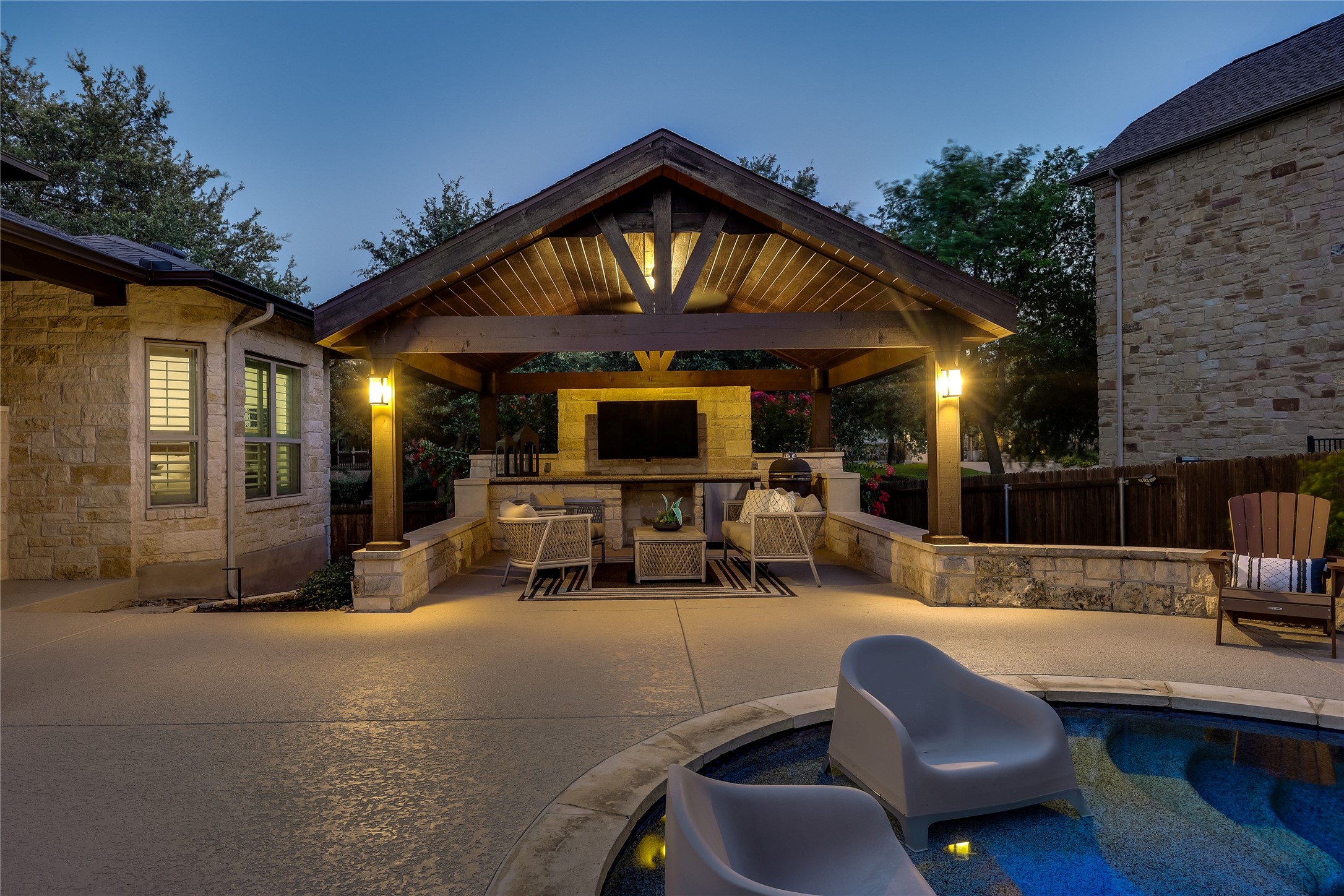 401 Bluff View Road Cedar Park, TX 78613 - Photo 15 of 40 An inviting outdoor living space features a covered patio with a built-in outdoor kitchen, perfect for entertaining.