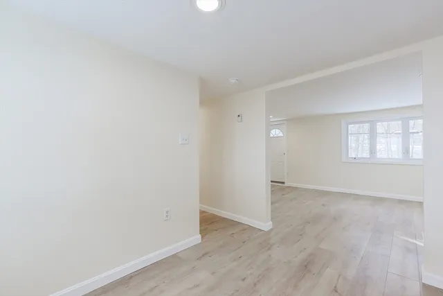 wooden floor in an empty room with a window