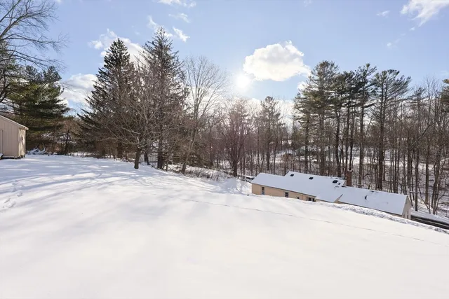 a view of a house with a yard covered in snow