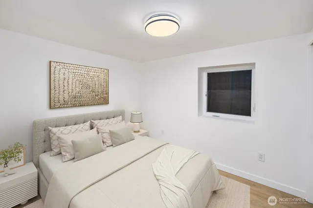 a bedroom with a bed and a window