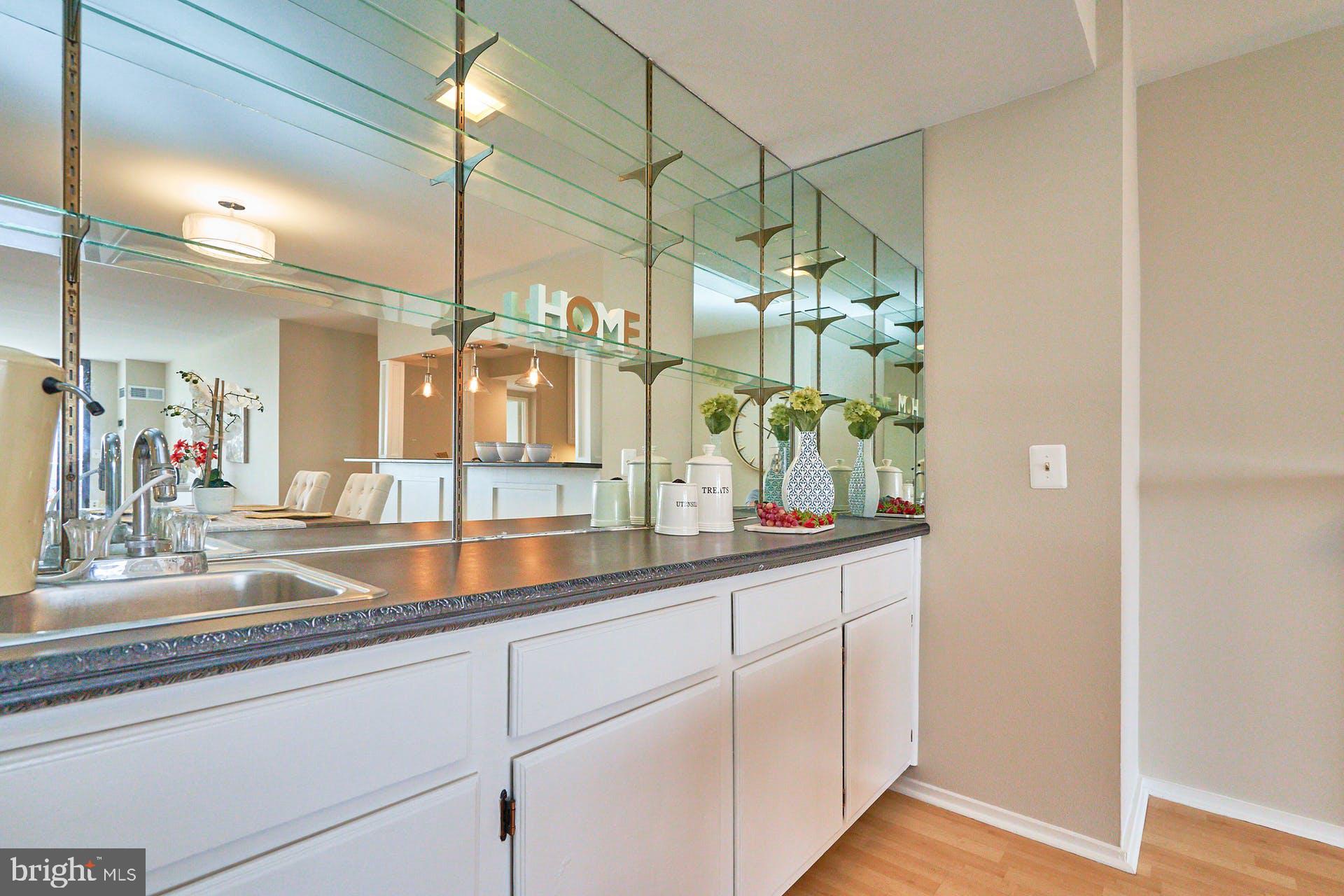 6101 Edsall Road, Unit 1707 Alexandria, VA 22304 - Photo 4 of 45 White kitchen cabinets and mirrors add depth