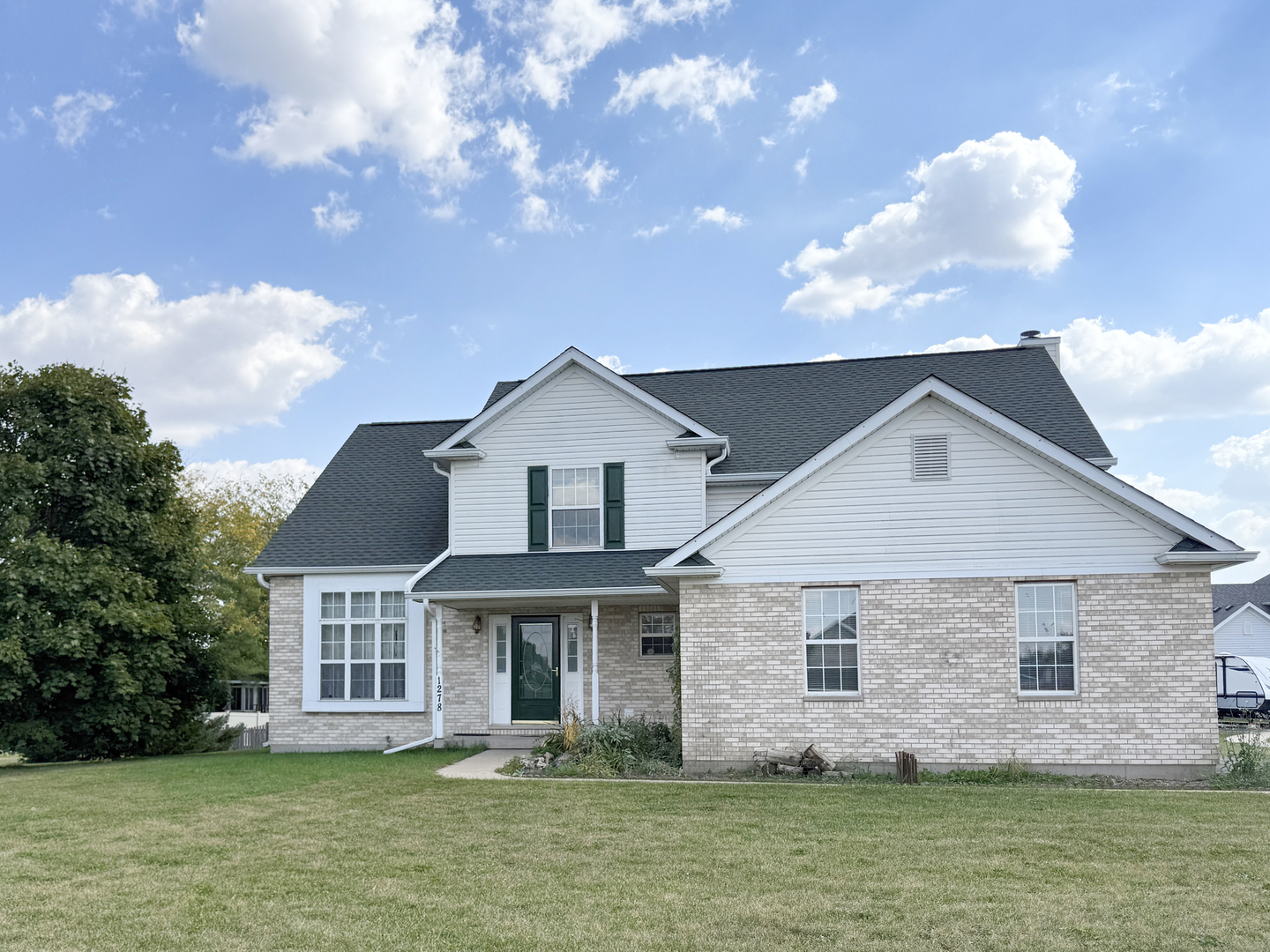 1278 Knolls Avenue South DeKalb, IL 60115 - Photo 1 of 35 a front view of a house with a yard and lake view