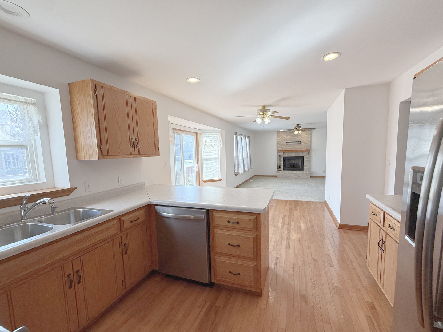 1278 Knolls Avenue South DeKalb, IL 60115 - Photo 11 of 35 a kitchen with a sink a refrigerator and wooden floor