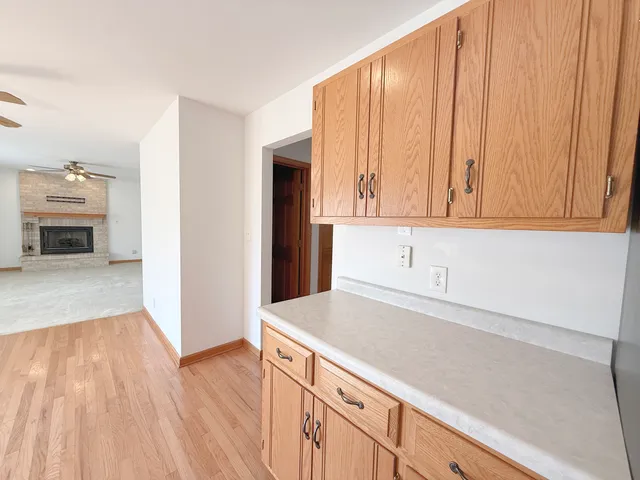 a kitchen with granite countertop wooden cabinets and sink