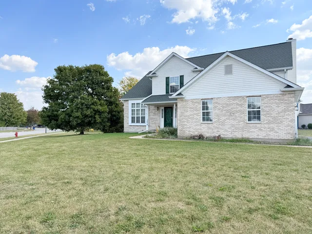 a view of a house with a yard and garage
