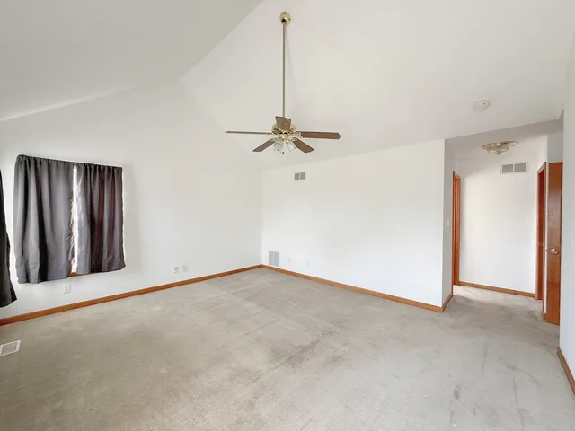 a view of a room with a ceiling fan
