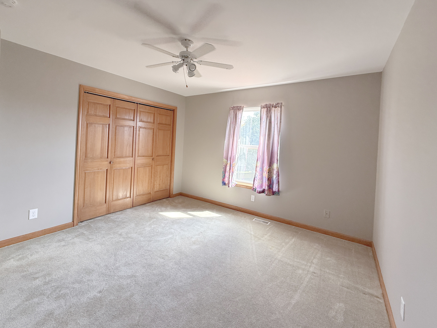 1278 Knolls Avenue South DeKalb, IL 60115 - Photo 30 of 35 an empty room with windows and chandelier fan