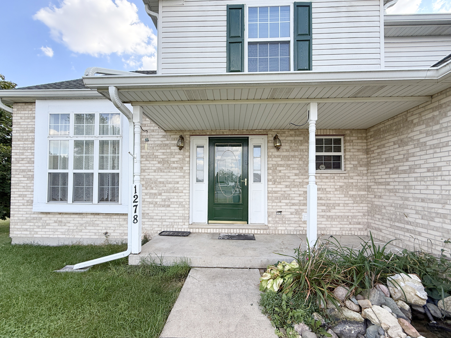 1278 Knolls Avenue South DeKalb, IL 60115 - Photo 3 of 35 a front view of a house with a yard