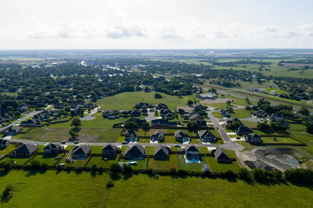 an aerial view of a house with a lake view