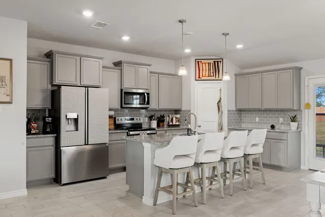 a living room with stainless steel appliances kitchen island granite countertop furniture and a kitchen view