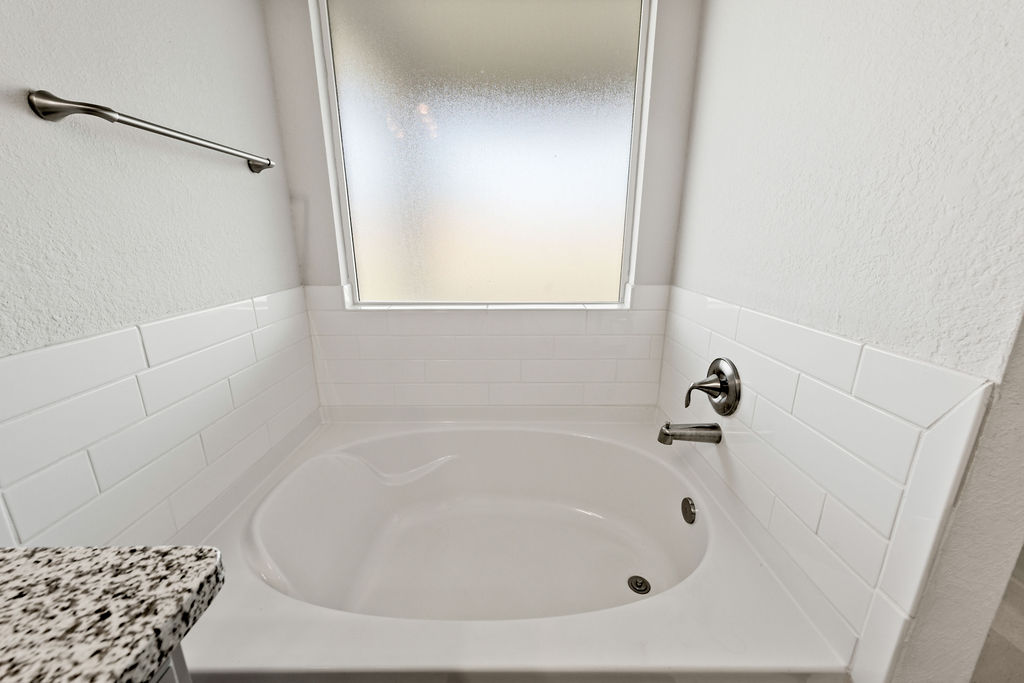 213 Gauge Road Thorndale, TX 76577 - Photo 26 of 40 a white bath tub sitting in a bathroom
