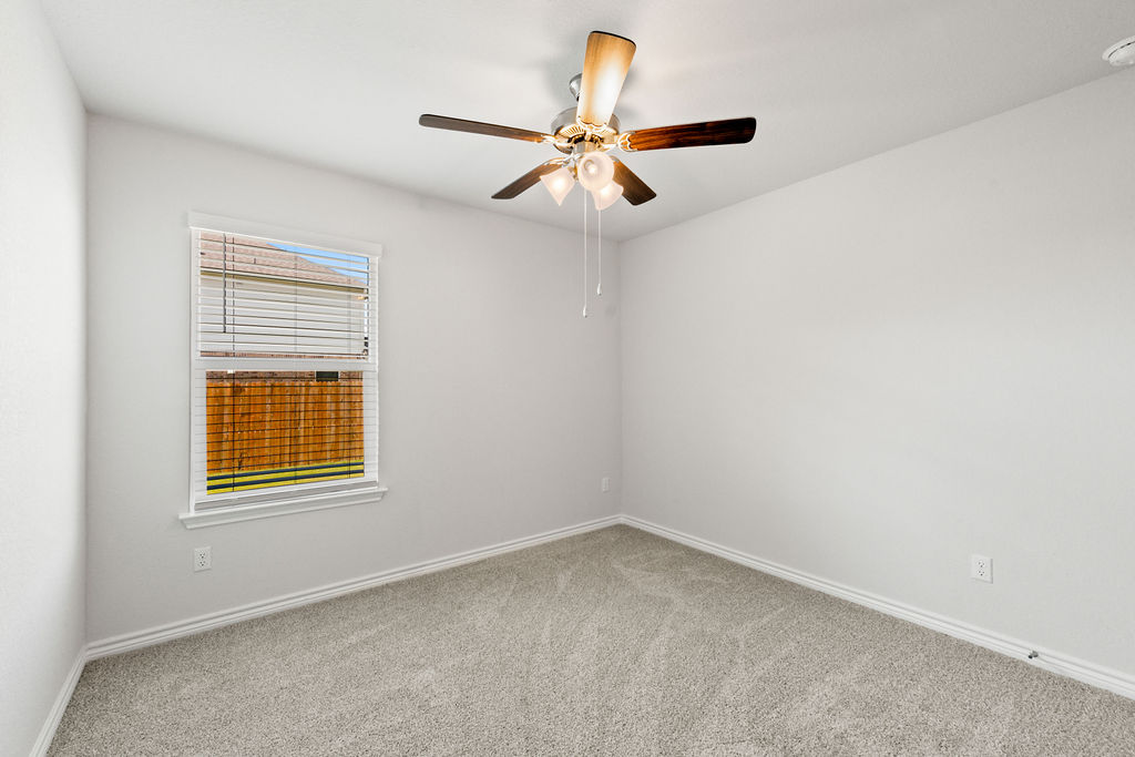 213 Gauge Road Thorndale, TX 76577 - Photo 29 of 40 an empty room with a window and a ceiling fan