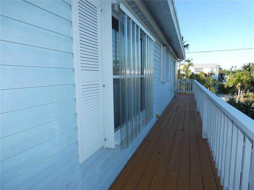 6814 Gull Lane Hudson, FL 34667 - Photo 21 of 51 a view of balcony with wooden floor