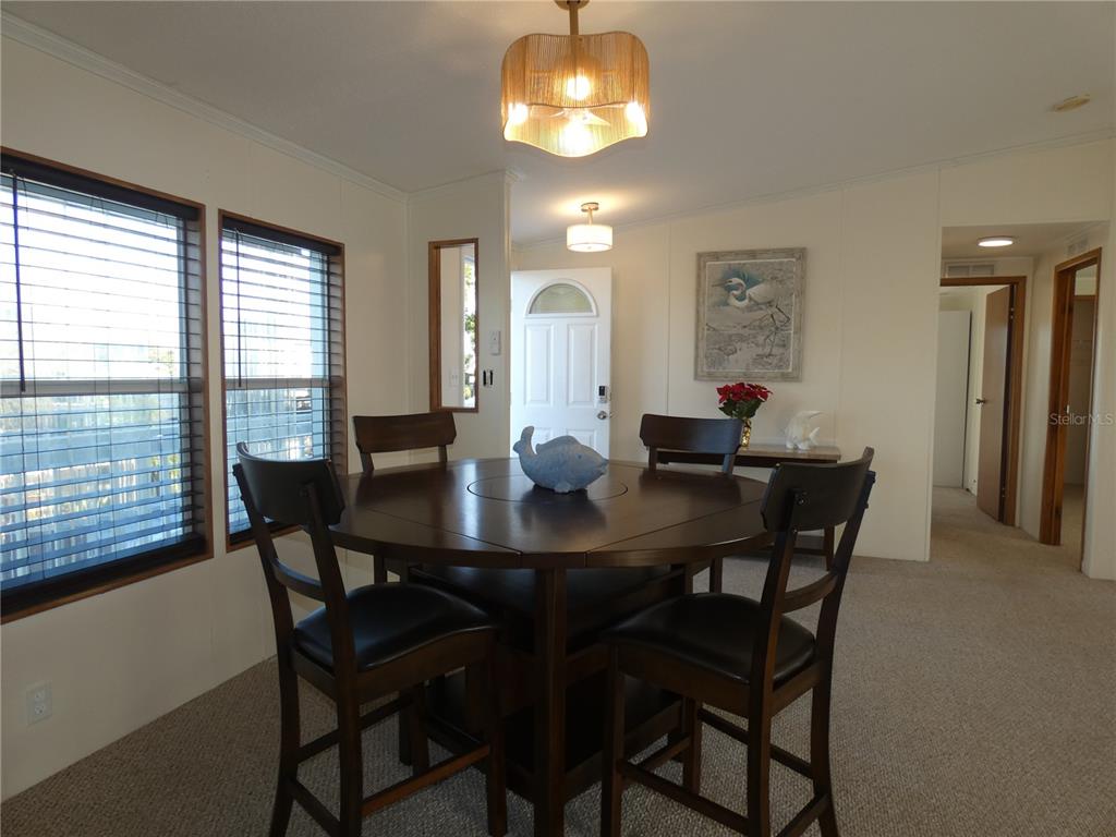 6814 Gull Lane Hudson, FL 34667 - Photo 29 of 51 a view of a dining room with furniture window and outside view