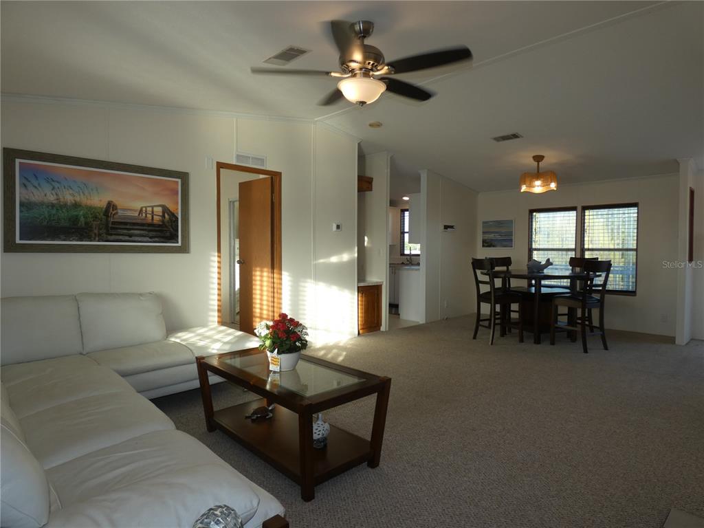 6814 Gull Lane Hudson, FL 34667 - Photo 31 of 51 a living room with furniture and a chandelier