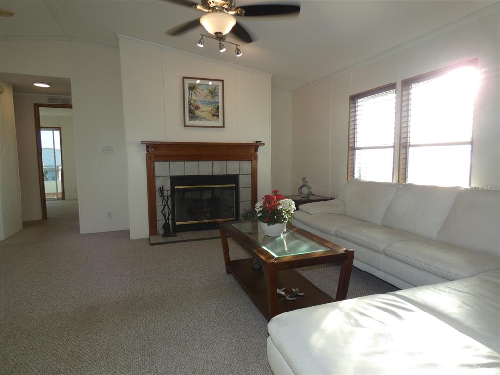 6814 Gull Lane Hudson, FL 34667 - Photo 32 of 51 a living room with furniture and a fireplace