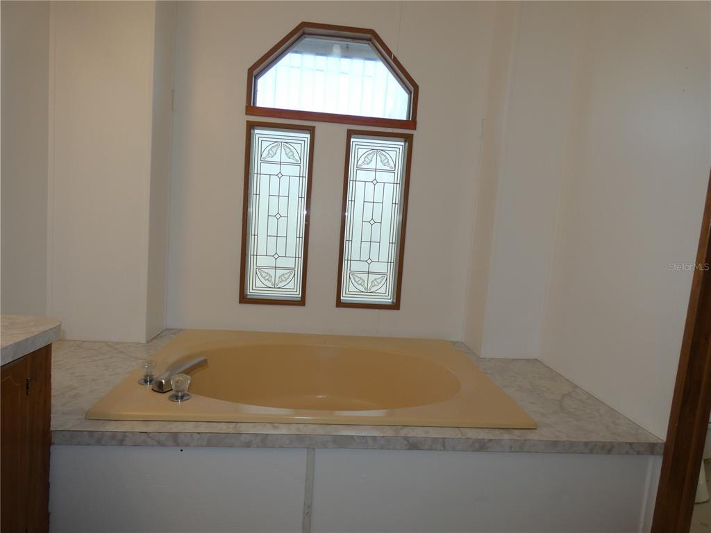 6814 Gull Lane Hudson, FL 34667 - Photo 37 of 51 a bathroom with a sink and a window