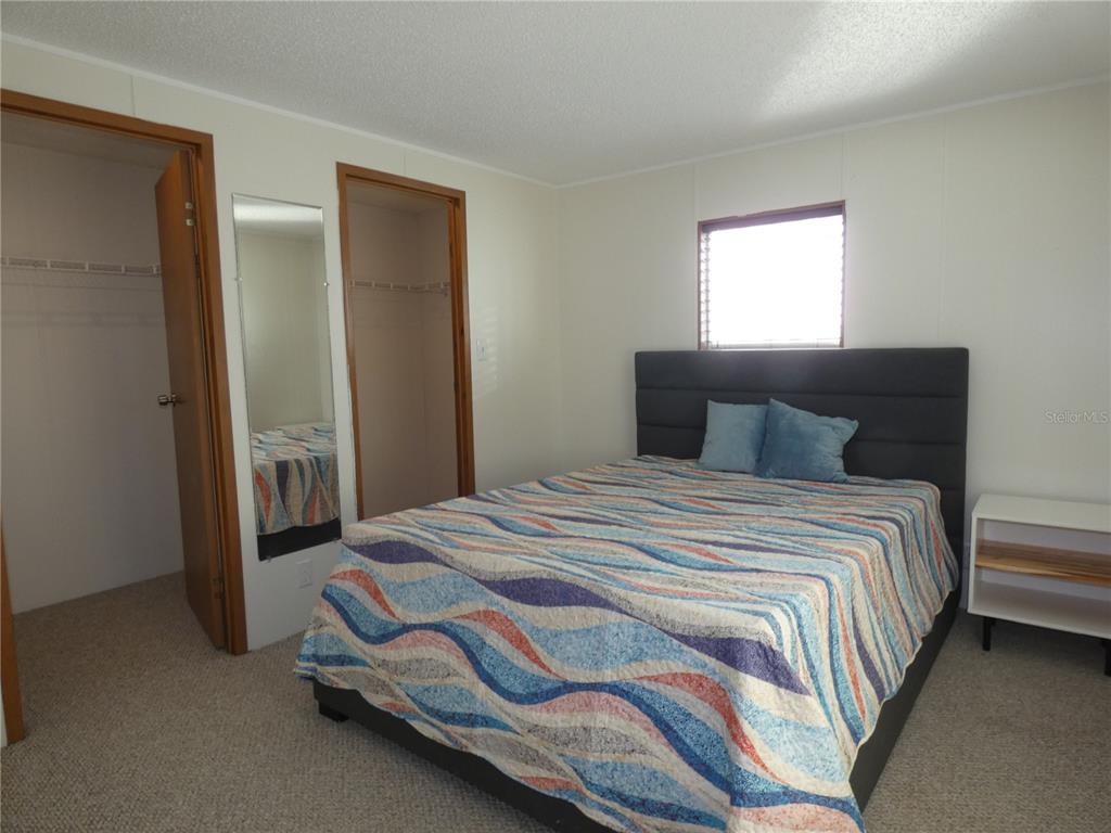 6814 Gull Lane Hudson, FL 34667 - Photo 40 of 51 a bedroom with a bed and a window