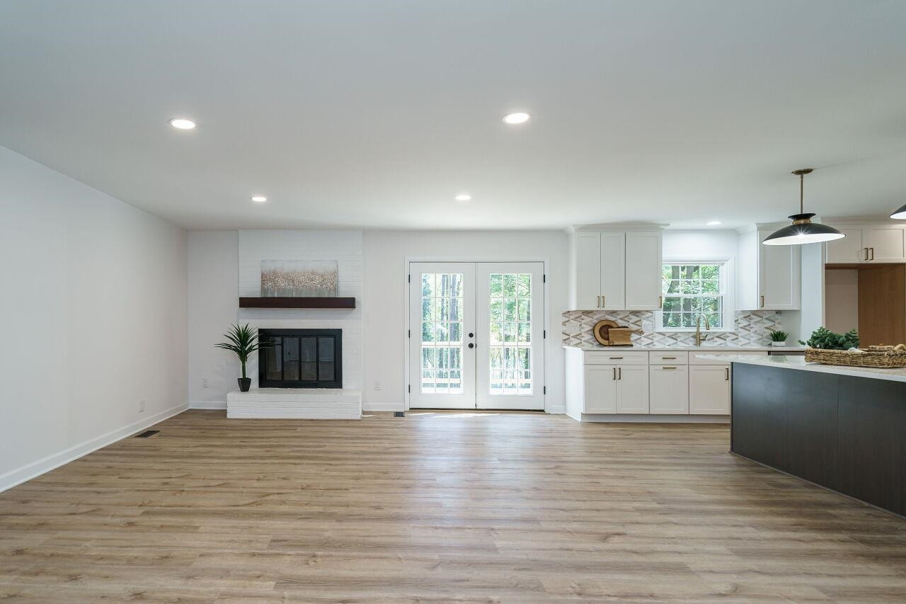 1436 Princess Anne Road Raleigh, NC 27607 - Photo 13 of 36 a large kitchen with kitchen island a sink dishwasher a stove and a refrigerator with wooden floor