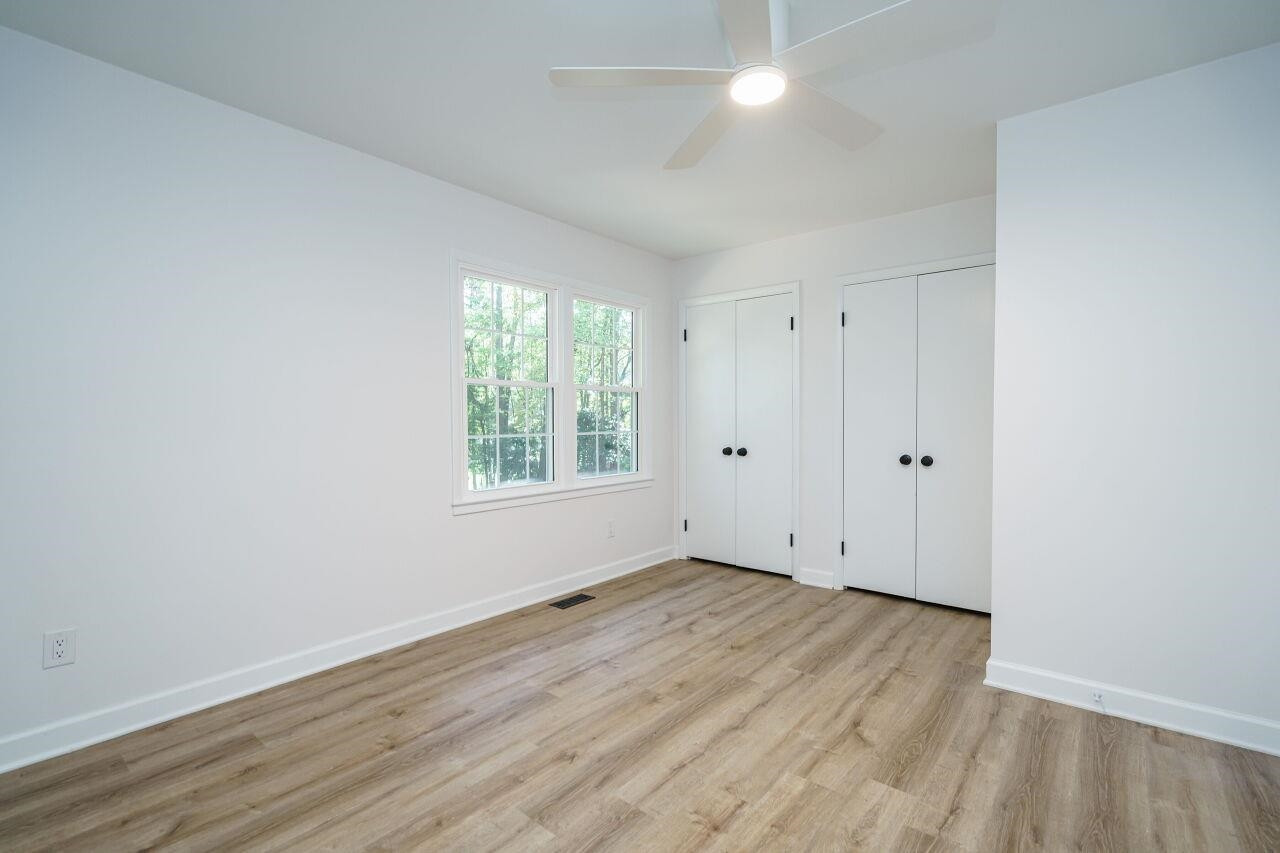 1436 Princess Anne Road Raleigh, NC 27607 - Photo 20 of 36 an empty room with wooden floor and windows