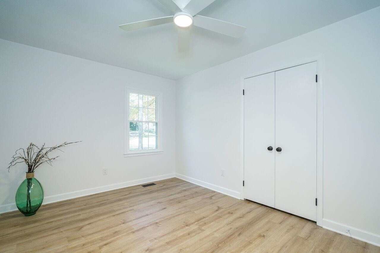 1436 Princess Anne Road Raleigh, NC 27607 - Photo 24 of 36 a view of an empty room with wooden floor and a window