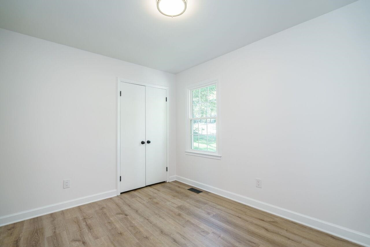 1436 Princess Anne Road Raleigh, NC 27607 - Photo 26 of 36 a view of an empty room with wooden floor and a window