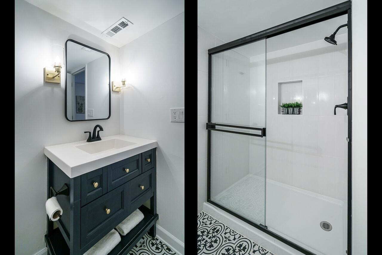 1436 Princess Anne Road Raleigh, NC 27607 - Photo 29 of 36 a bathroom with a shower sink and mirror
