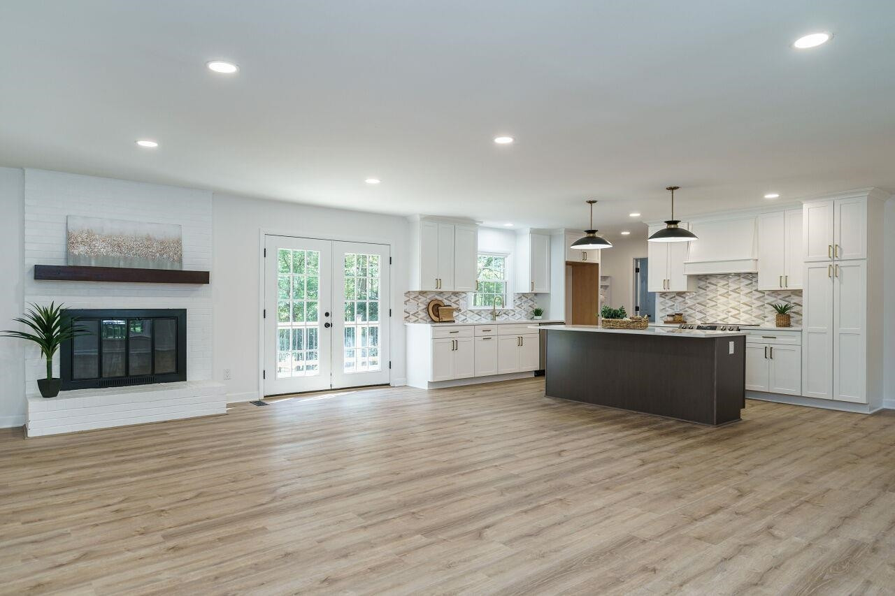1436 Princess Anne Road Raleigh, NC 27607 - Photo 3 of 36 a large kitchen with stainless steel appliances granite countertop a large counter top and a fireplace