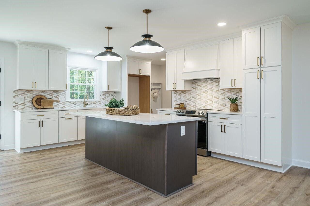 1436 Princess Anne Road Raleigh, NC 27607 - Photo 6 of 36 a kitchen with kitchen island granite countertop a sink a counter space appliances and cabinets