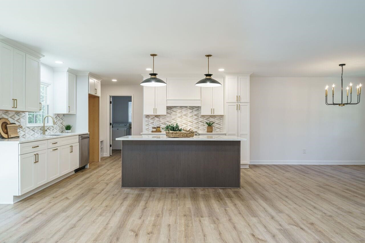 1436 Princess Anne Road Raleigh, NC 27607 - Photo 7 of 36 a large kitchen with kitchen island white cabinets and stainless steel appliances