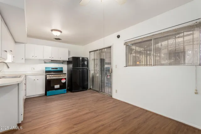 a kitchen with stainless steel appliances a refrigerator sink and cabinets