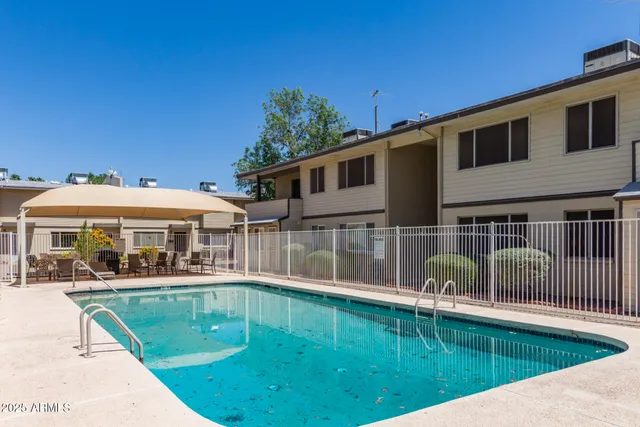 a view of a house with a backyard patio and sitting area