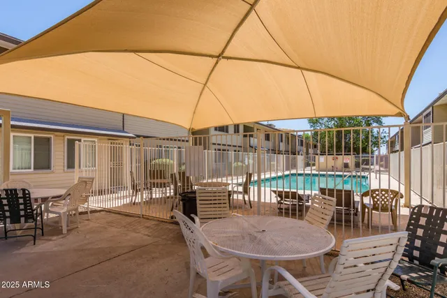 a outdoor space with lots of tables a chairs and a couch