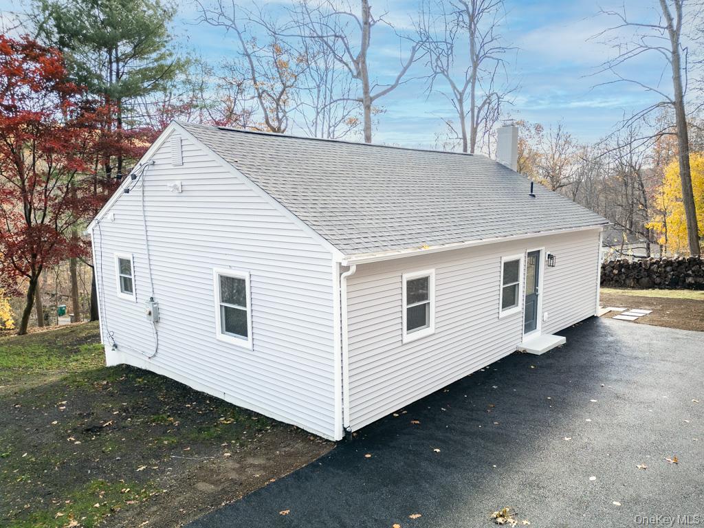 a view of a white house with a yard