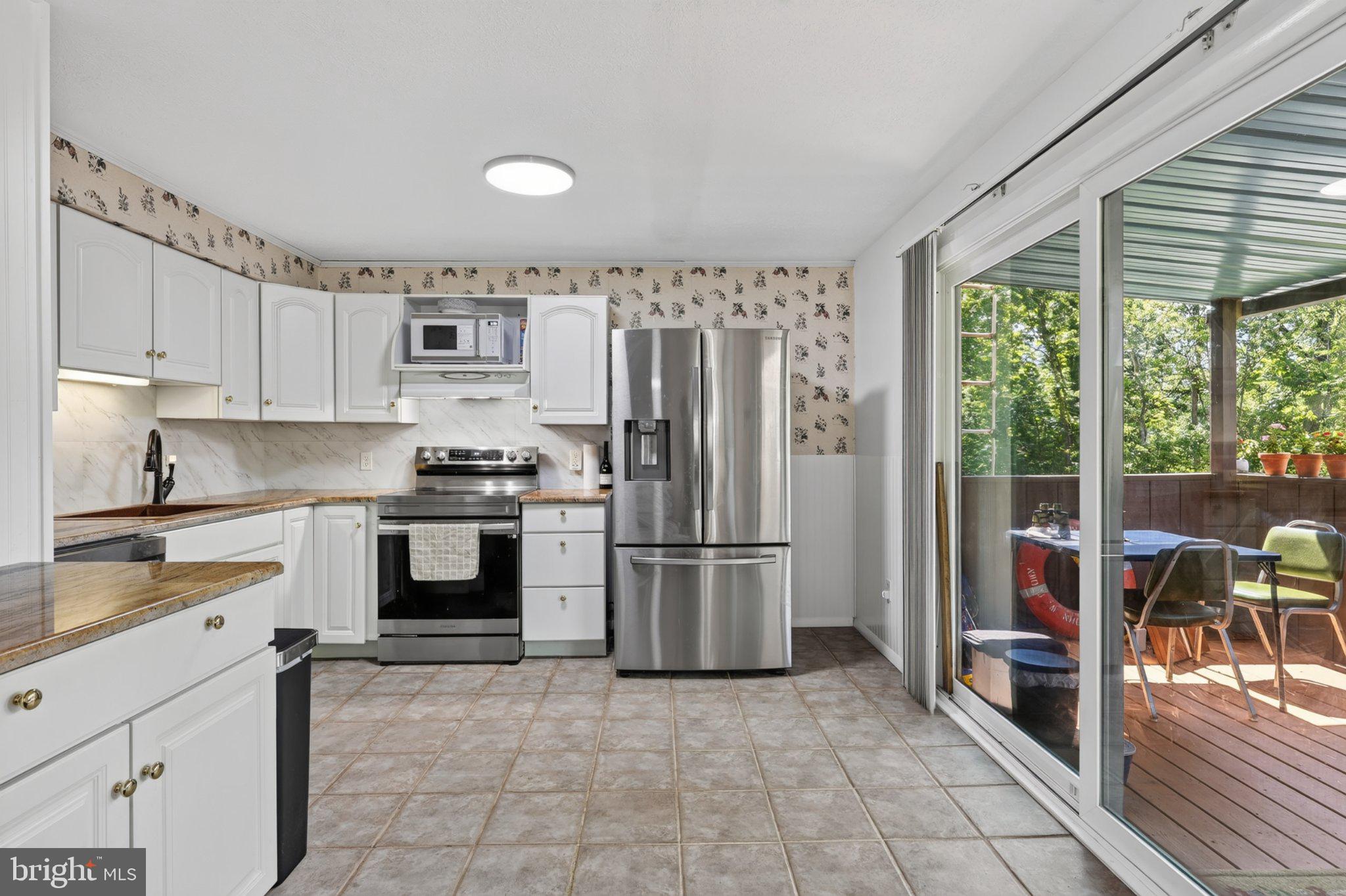 274 The Hill Road, Unit 13A Basye, VA 22810 - Photo 3 of 12 Bright kitchen with outdoor access.
