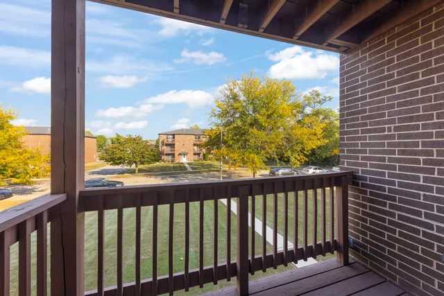 a view of a balcony with wooden floor