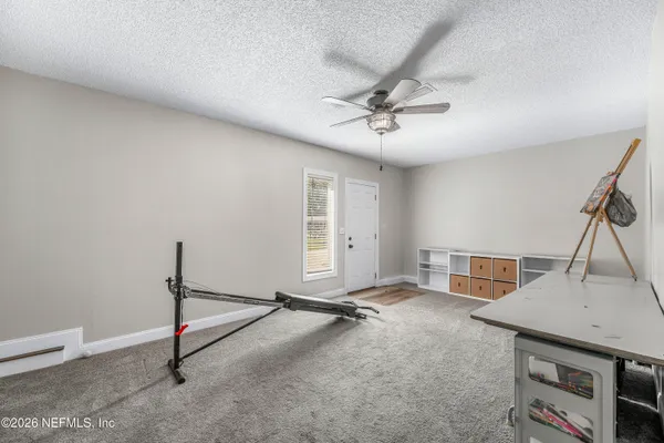 a view of a room with gym equipment and windows