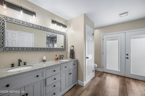 a bathroom with a toilet and a mirror