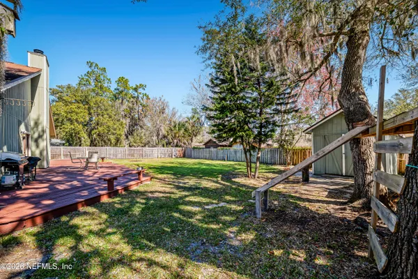 a view of a backyard with a tree