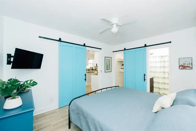 a bedroom with a bed and a potted plant