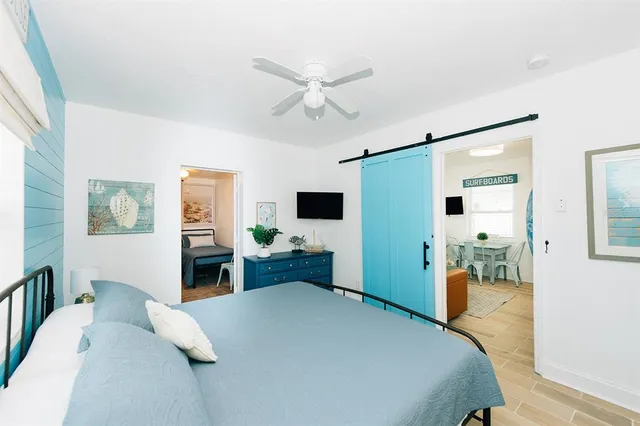 a bedroom with a bed and a flat screen tv