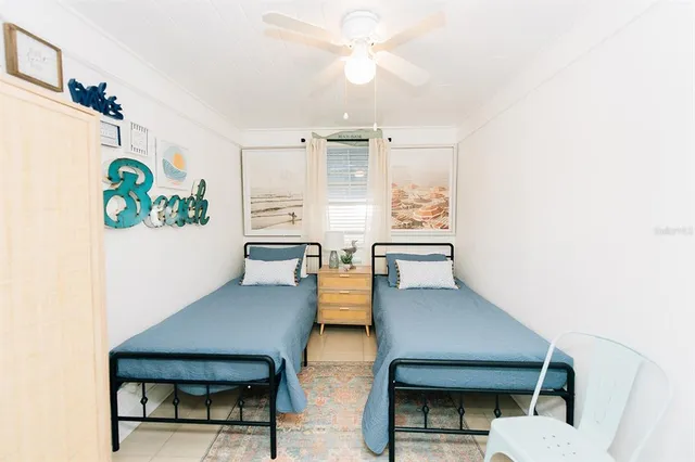 a living room with couches and kitchen view with wooden floor
