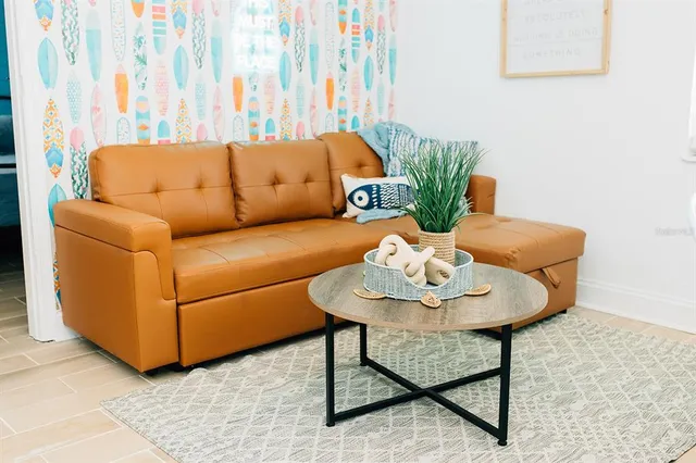 a living room with furniture and a potted plant