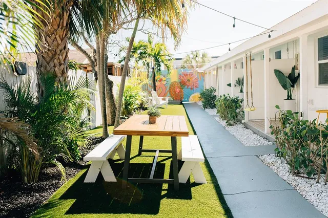 a view of a yard with potted plants