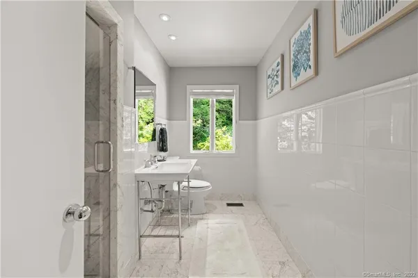 a bathroom with a bathtub a sink and a window