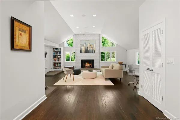 a living room with fireplace furniture and a wooden floor