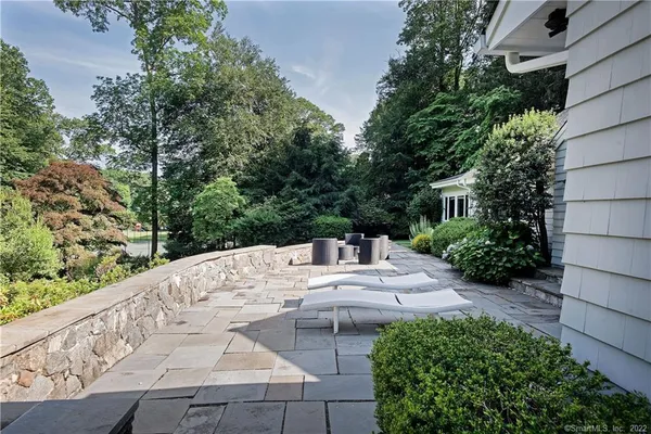 a view of house with backyard outdoor seating and green space