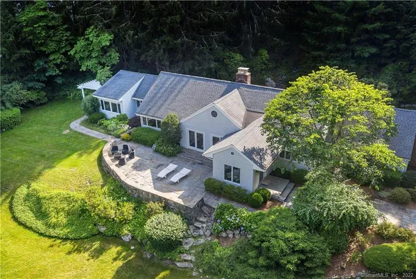 a aerial view of a house with swimming pool and garden