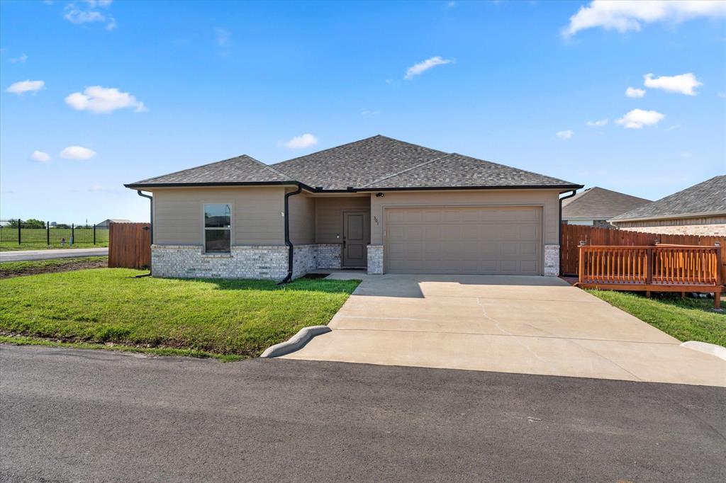 301 Hoover Drive Mabank, TX 75147 - Photo 1 of 1 a front view of house with yard and trees