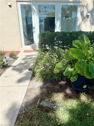 a garden with a lot of flower plants and wooden fence